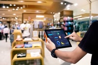 smart-store-management-systems-conceptmanager-using-digital-tablet-blurred-store-as-background